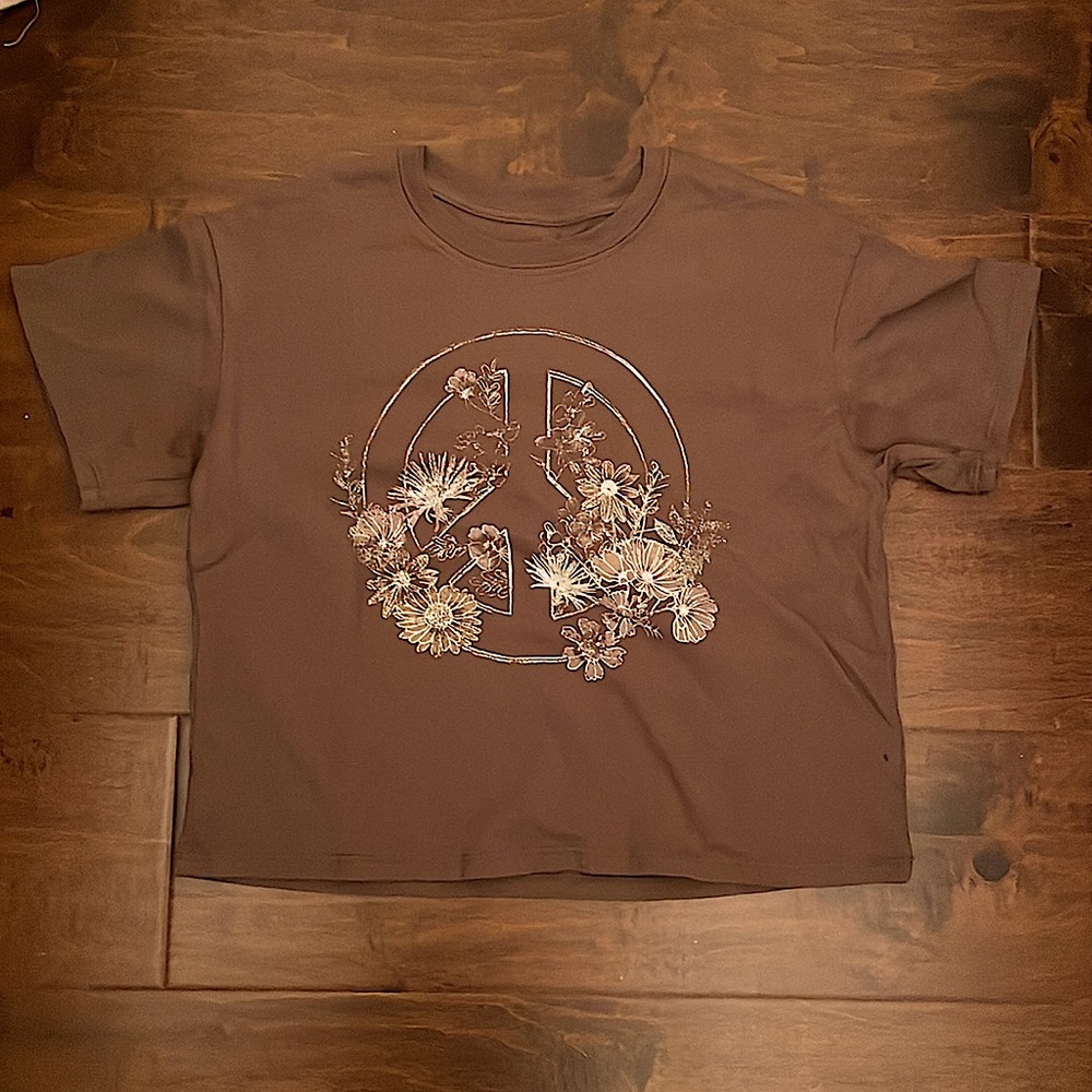 This peace sign T-shirt is Kat and Jack brand. It’s mostly brown Some white.